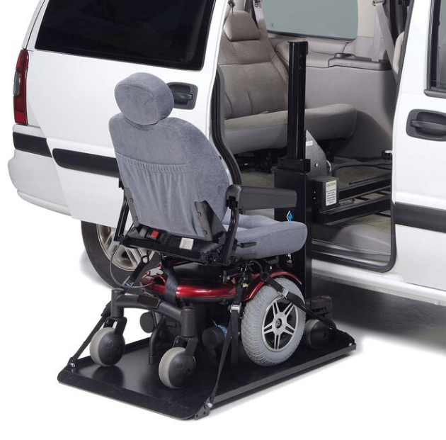 Interior platform scooter lift loading a power wheelchair through a minivan side door for safe vehicle transport