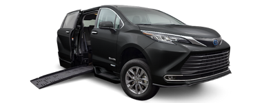 Wheelchair accessible Toyota Sienna handicap van with BraunAbility power fold-out ramp. Exterior view of front and passenger side of vehicle with wheelchair ramp deployed.