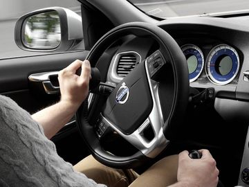 Person driving vehicle with hand cnotrols and spinner knob