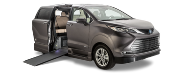 Wheelchair accessible Toyota Sienna handicap van with VMI Northstar power in-floor ramp. Exterior view of front and passenger side of vehicle with wheelchair ramp deployed.