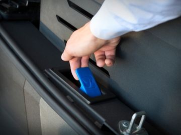 Hand operating latch to deploy the fold-out ramp in a Chrysler Pacifica rear-entry wheelchair van