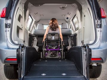 Wheelchair user seated in the second row of a BraunAbility Chrysler Pacifica rear-entry wheelchair van
