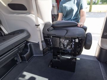 Second-row jump seat in stowed position installed a BraunAbility Chrysler Pacifica wheelchair van