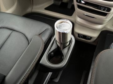 Cupholders attached to driver seat in a BraunAbility Chrysler Pacifica wheelchair van
