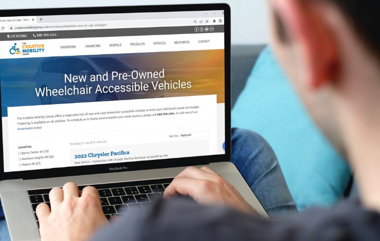 Person using laptop to shop for a wheelchair accessible van online