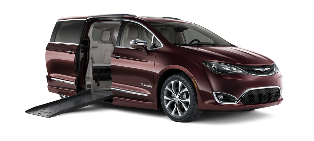 Front and passenger side exterior view of red wheelhciar accessible BraunAbility Chrysler Pacifica with ramp deployed