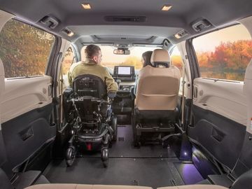 Person driving a wheelchair accessible van from his power wheelchair