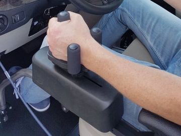 Right hand positioned in tri-pin handle of low-effort hand control