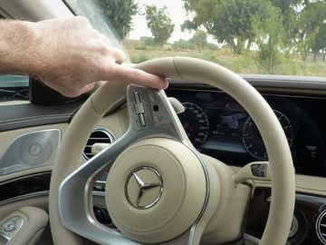 Person using index finger to turn a steering wheel