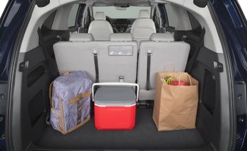 Cargo space behind the third-row seat in a BraunAbility Honda Odyssey wheelchair van filled with a cooler and groceries