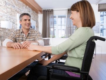 Two people seated at a table drinking coffee