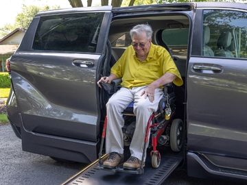 Man in power wheelcair exiting a BraunAbility Toyota Sienna wheelchair accessible minivan