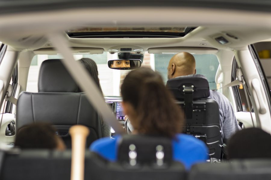 Interior view of wheelchair accessible van. The front passenger is secured in a power wheelchair.
