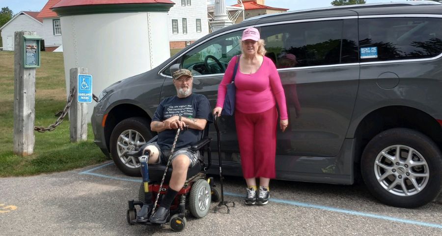 Husband and wife beside a side-entry wheelchair accessible van