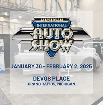 Promotional image for the 2025 Michigan International Auto Show at DeVos Place in Grand Rapids, Michigan, from January 30 to February 2, 2025. The Michigan International Auto Show logo is prominently displayed in the center. The background features an indoor exhibition space with a white wheelchair-accessible vehicle on display, surrounded by informational signage and banners.