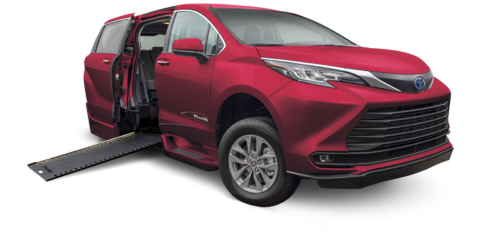 Red Toyota Sienna hybrid wheelchair accessible van with power in-floor ramp deployed.
