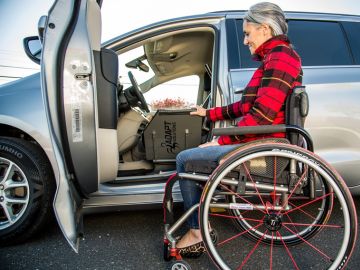 Adapt Solutions XL-Seat powered transfer board assisting with vehicle entry and exit