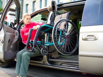 Adapt Solutions Hi-Lift wheelchair lift system raising a manual wheelchair into a minivan