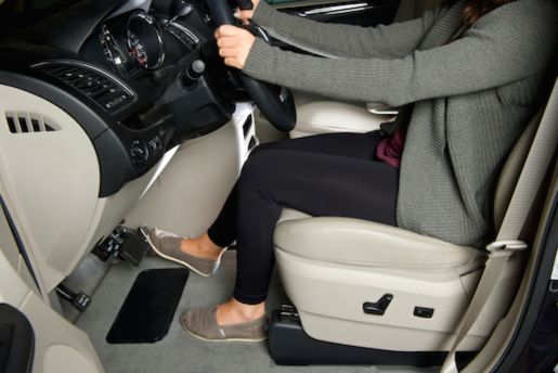 Driver using PedalMates pedal extenders to sit at a safe distance from the steering wheel while comfortably reaching pedals
